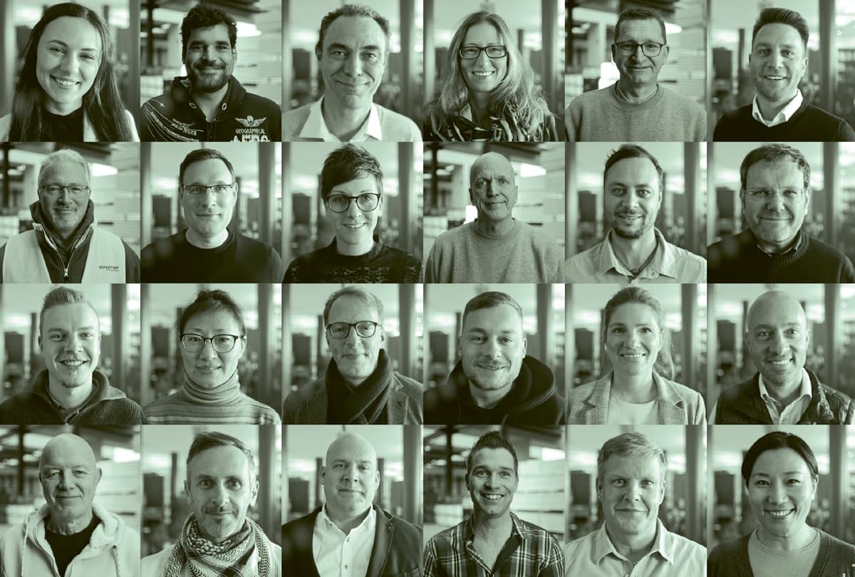 A grid of 20 diverse individuals against a blurred indoor background. They are all facing forward and smiling. The image has a green tint.