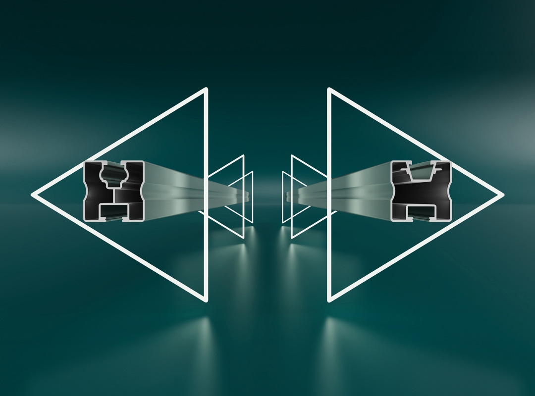 Two identical abstract geometric figures stand facing each other, composed of triangular frames and hollow, letter-like shapes, set in a surreal, green-toned environment.